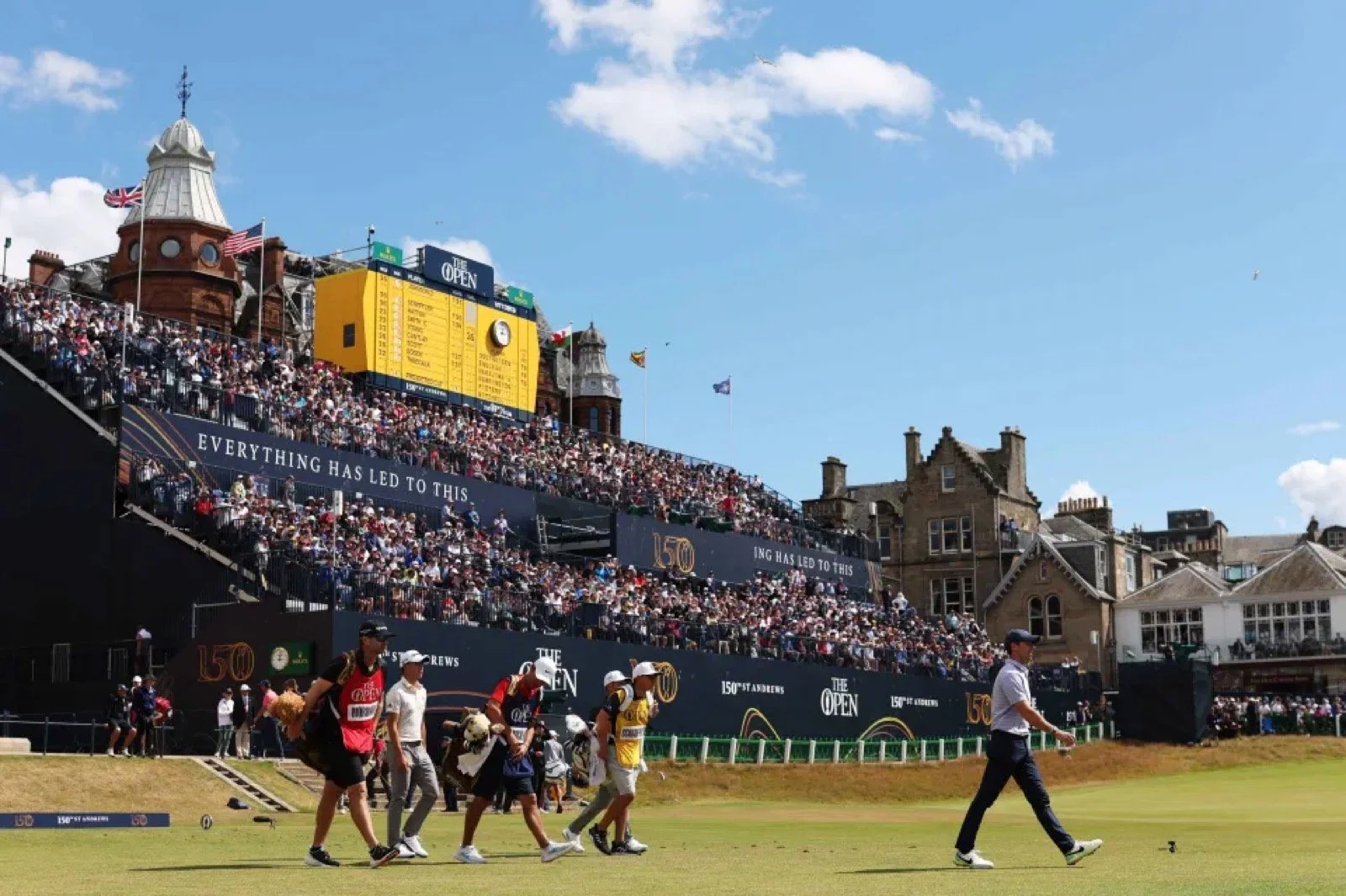 Players walking the 18th at St Andrews past the packed grandstand during The Open