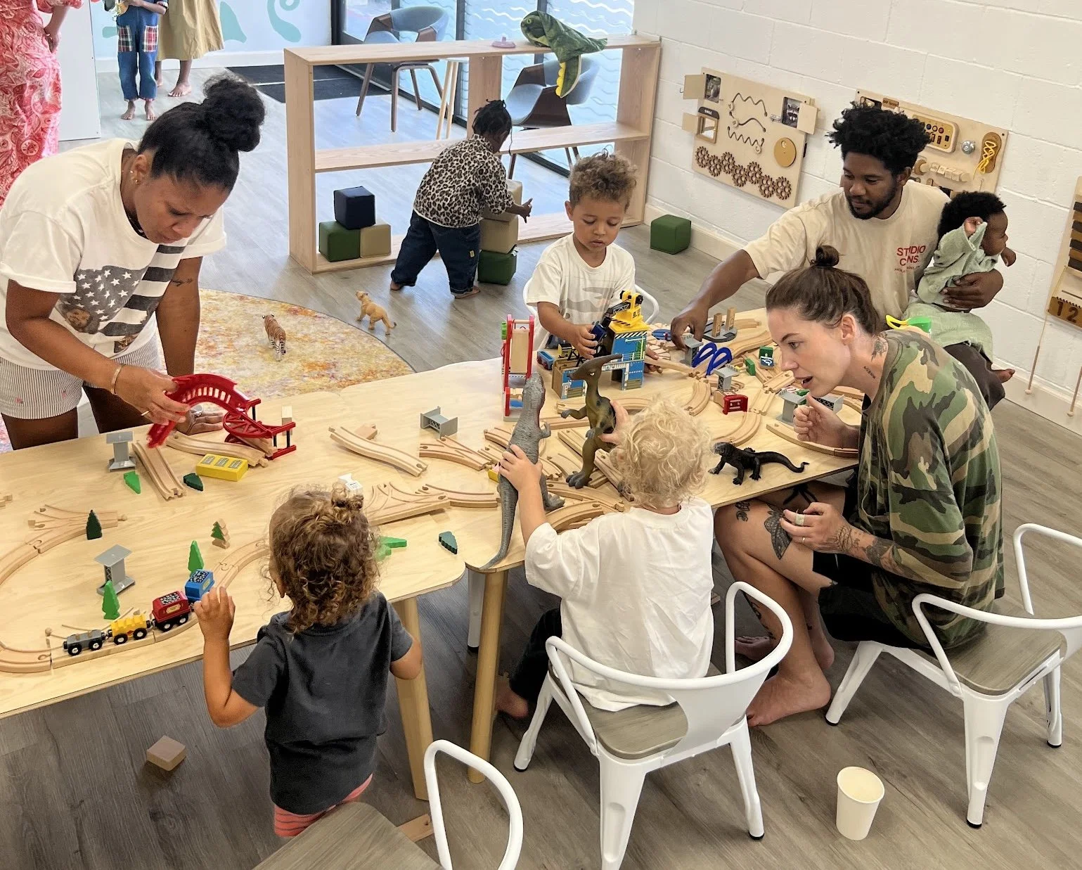 Children playing with wooden train table at PlayLab Hollywood indoor playground