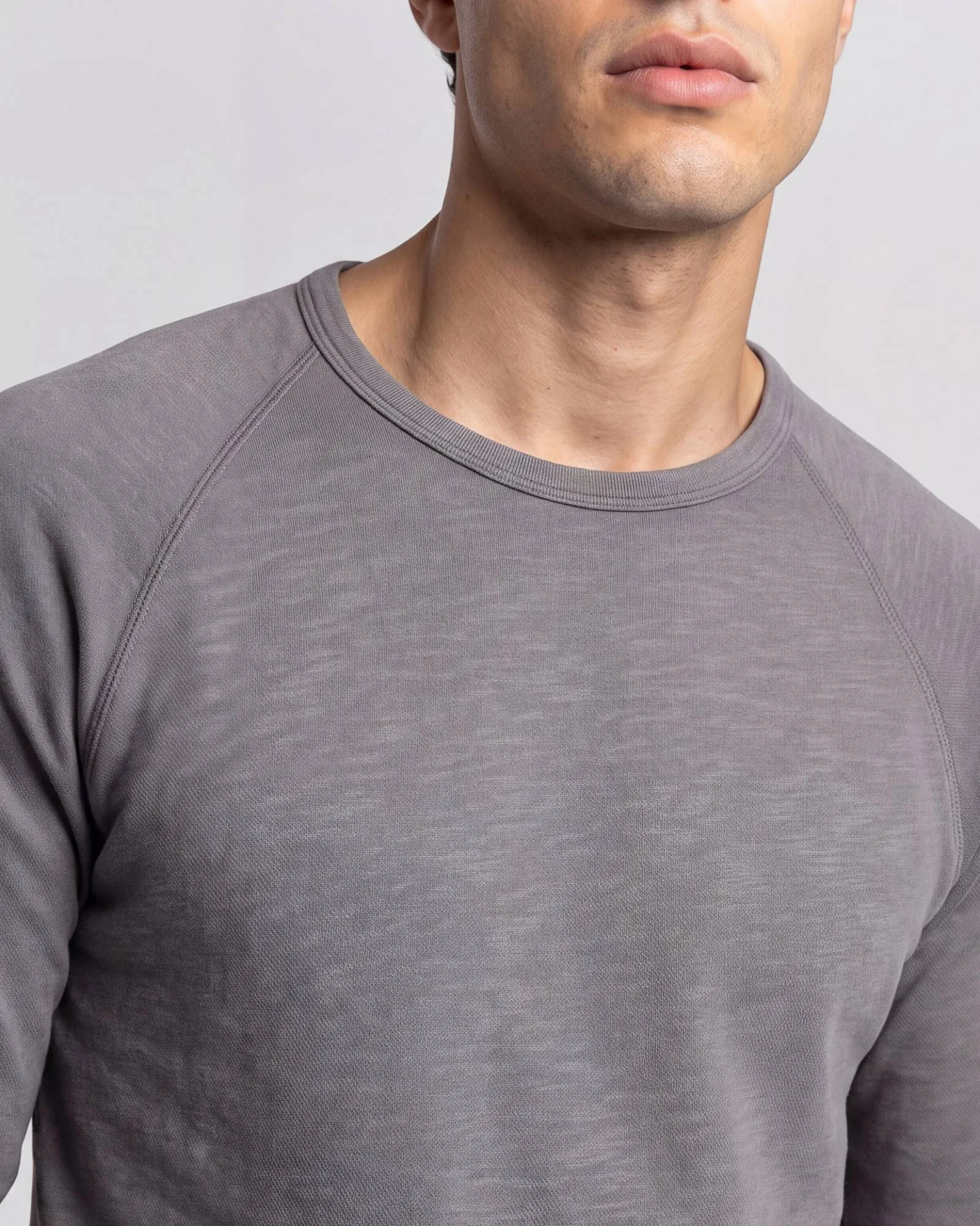 AI ecomm image, men's slub raglan crew, neckline detail