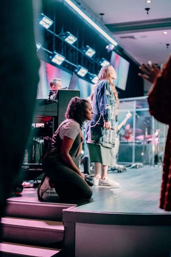 People praying together at the front of the room