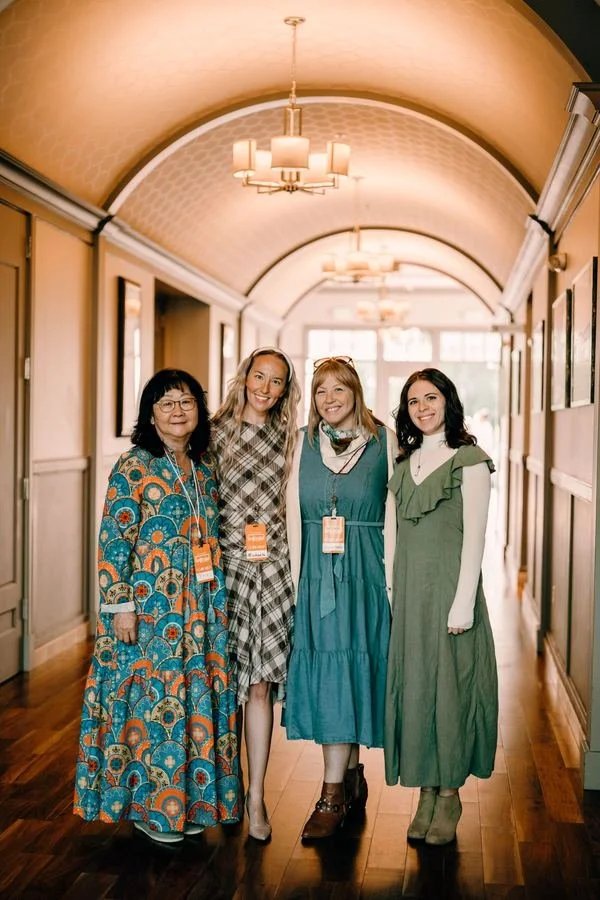 Four women standing together in the church hallway