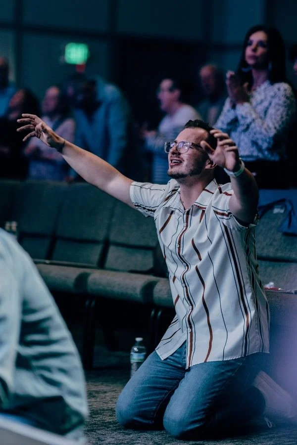 A man worshipping with his arm raised