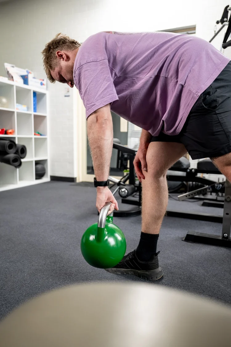 A worker practising safe lifting technique