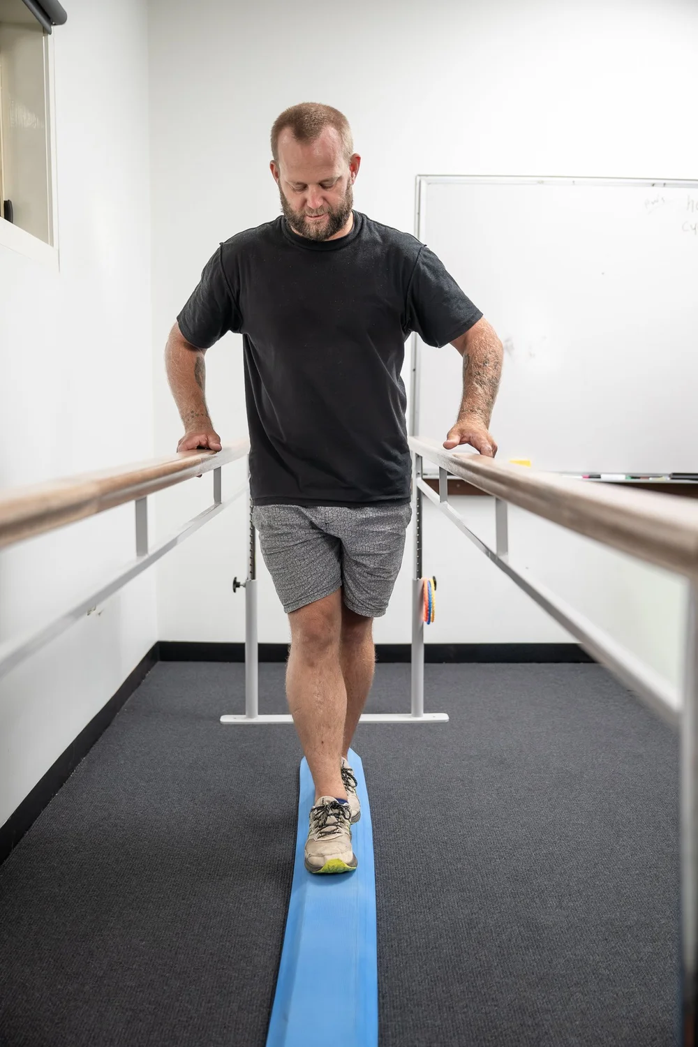 A client rebuilding balance between parallel bars