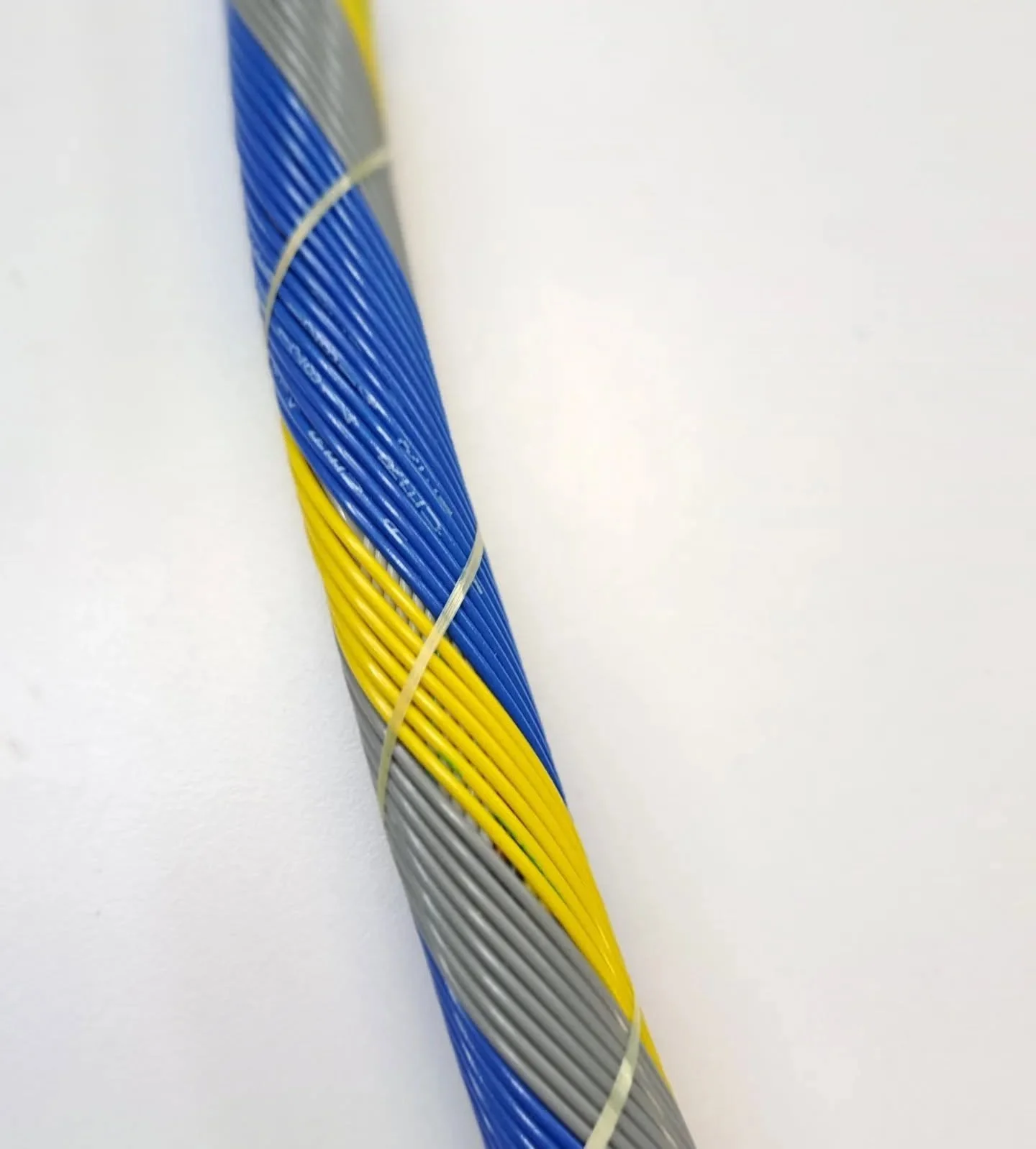 Blue, yellow and gray wires in a concentric harness layup