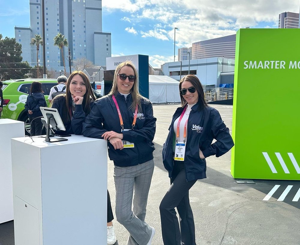 Trade show models supporting a brand booth at an expo