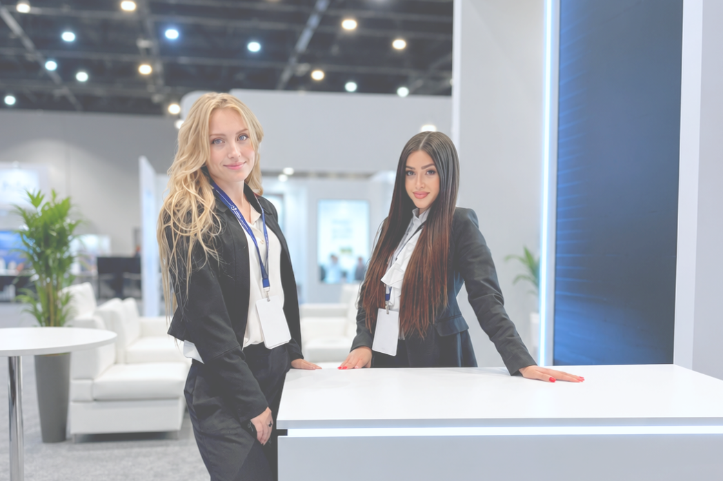 Professional trade show hostesses supporting an exhibitor booth