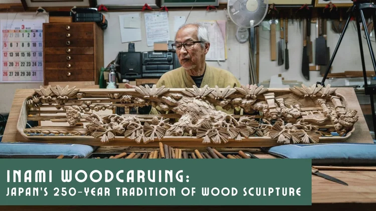 Image of an older Japanese man with a table full of intricately carved wooden sculptures that are usually featured above door frames in Japanese houses.