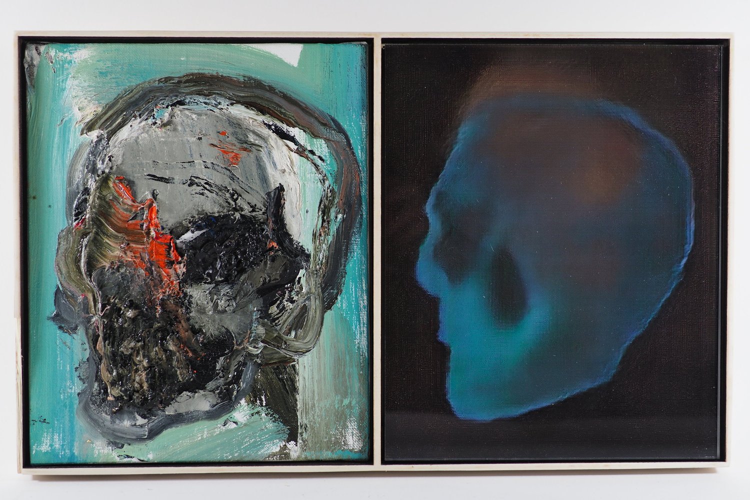 A framed pair: a thickly painted grey skull on teal beside a soft blue GAN skull on black