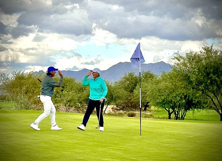 Lynn & Pia high five on course