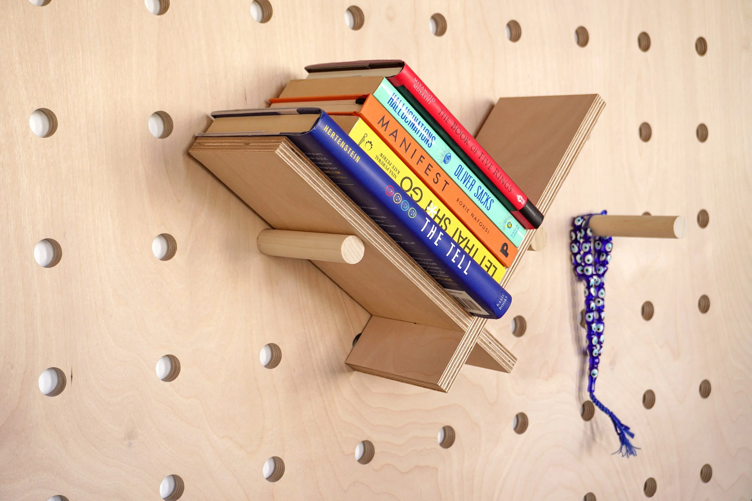 Modern wooden pegboard bookshelf and accessories