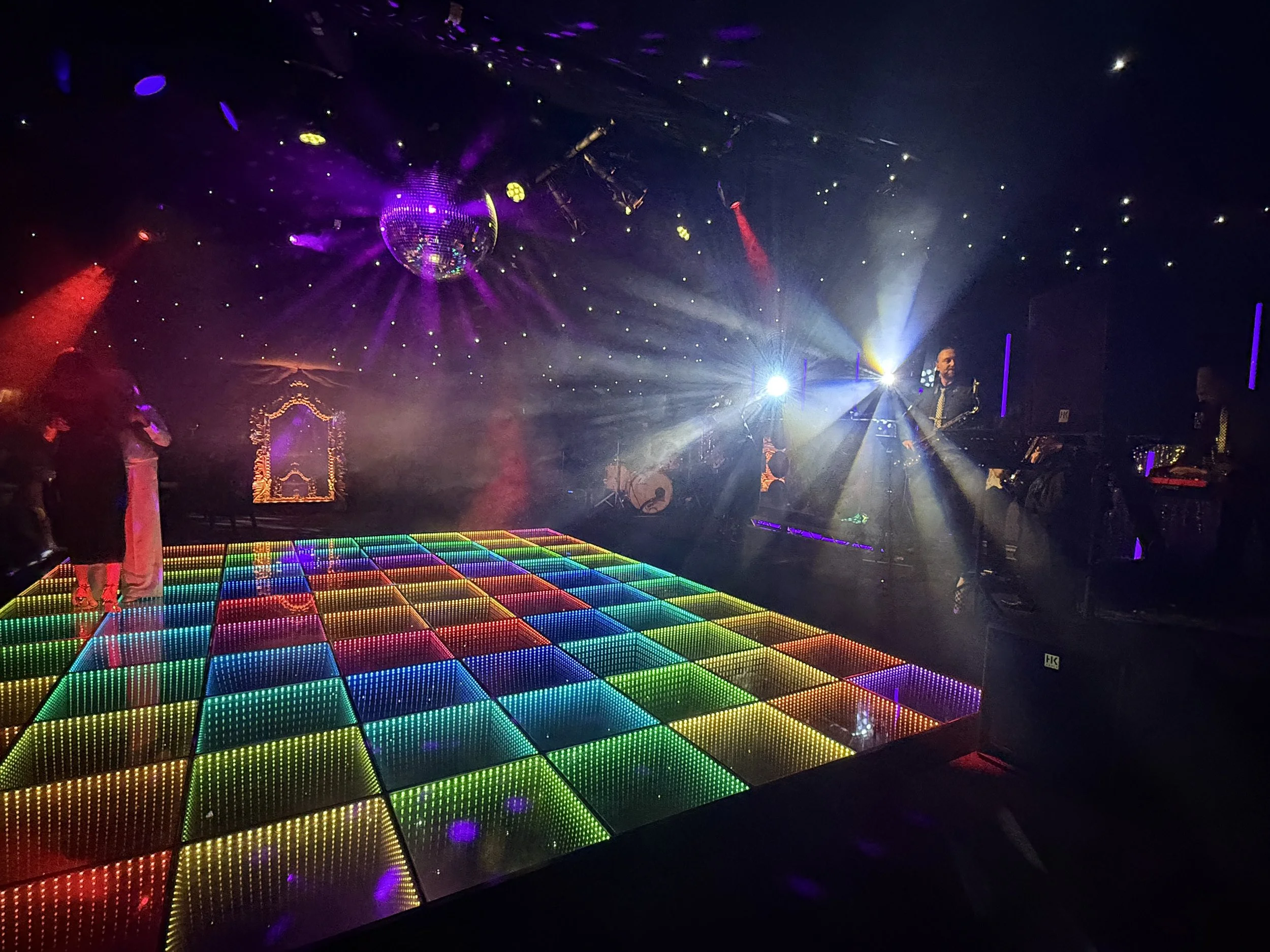 Beautifully decorated wedding setup with floral arrangements and a dancefloor
