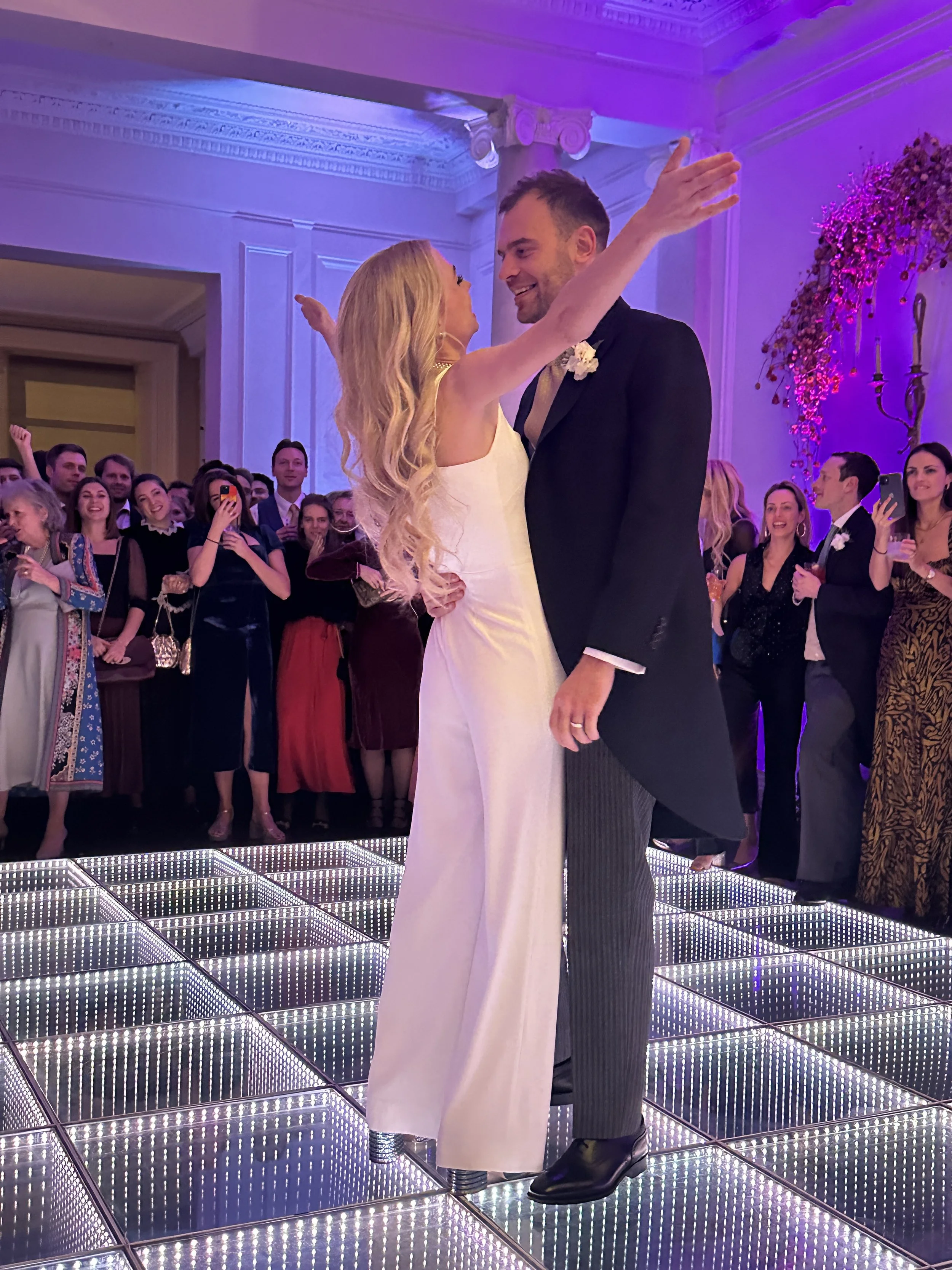 Guests dancing on a 3D Infinity Dancefloor with dramatic lighting at a luxury Cheshire wedding