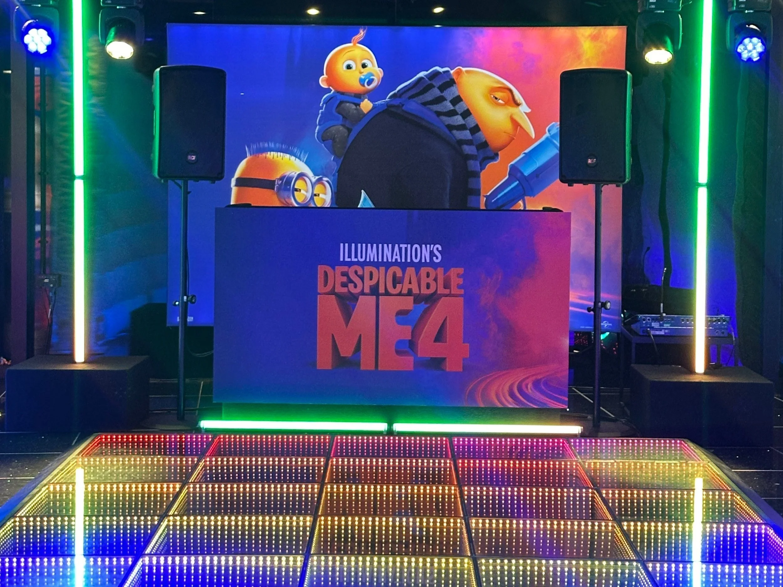Crew setting up an event with colorful stage lights