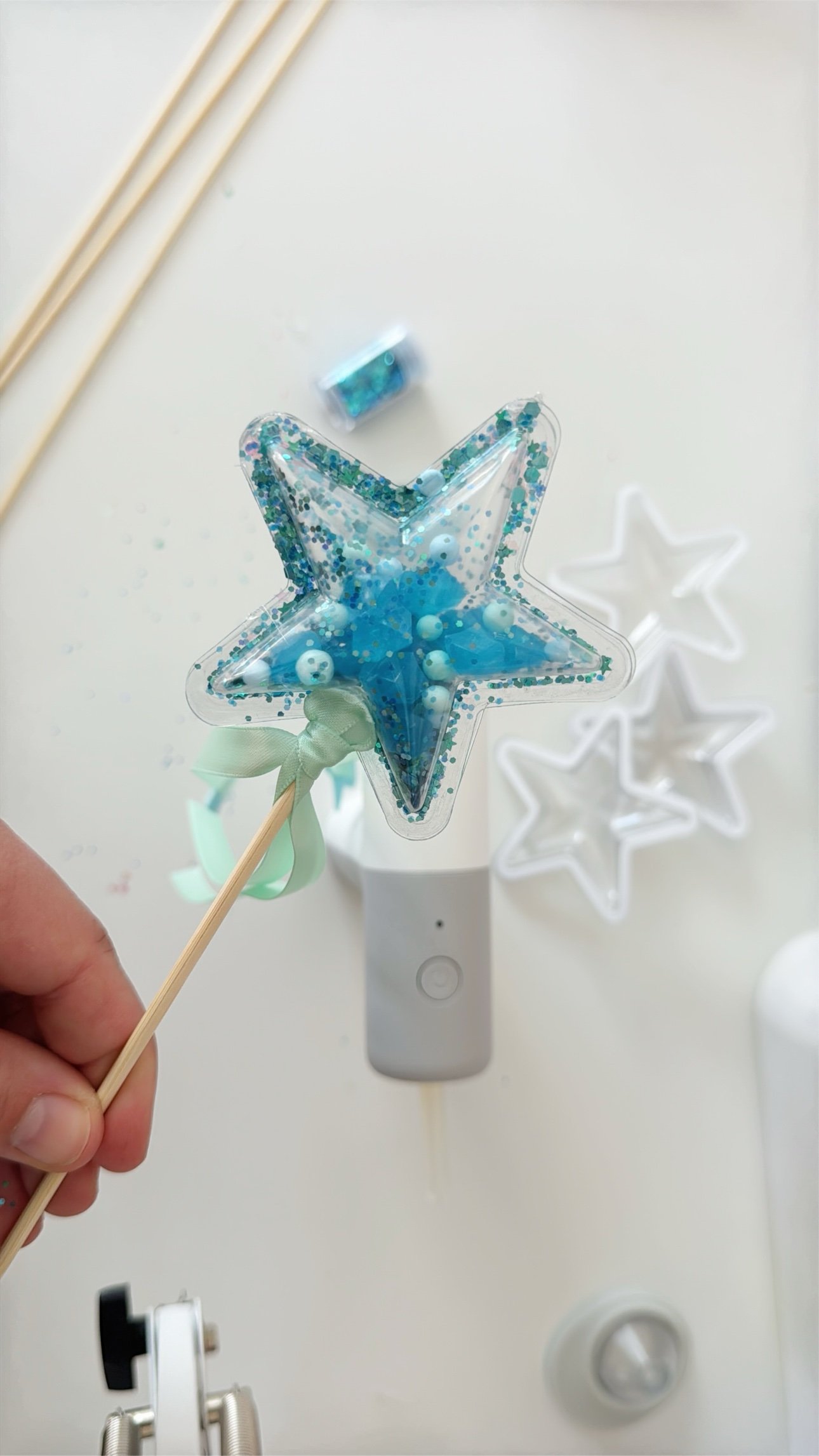Finished teal glitter star shaker wand with mint ribbon