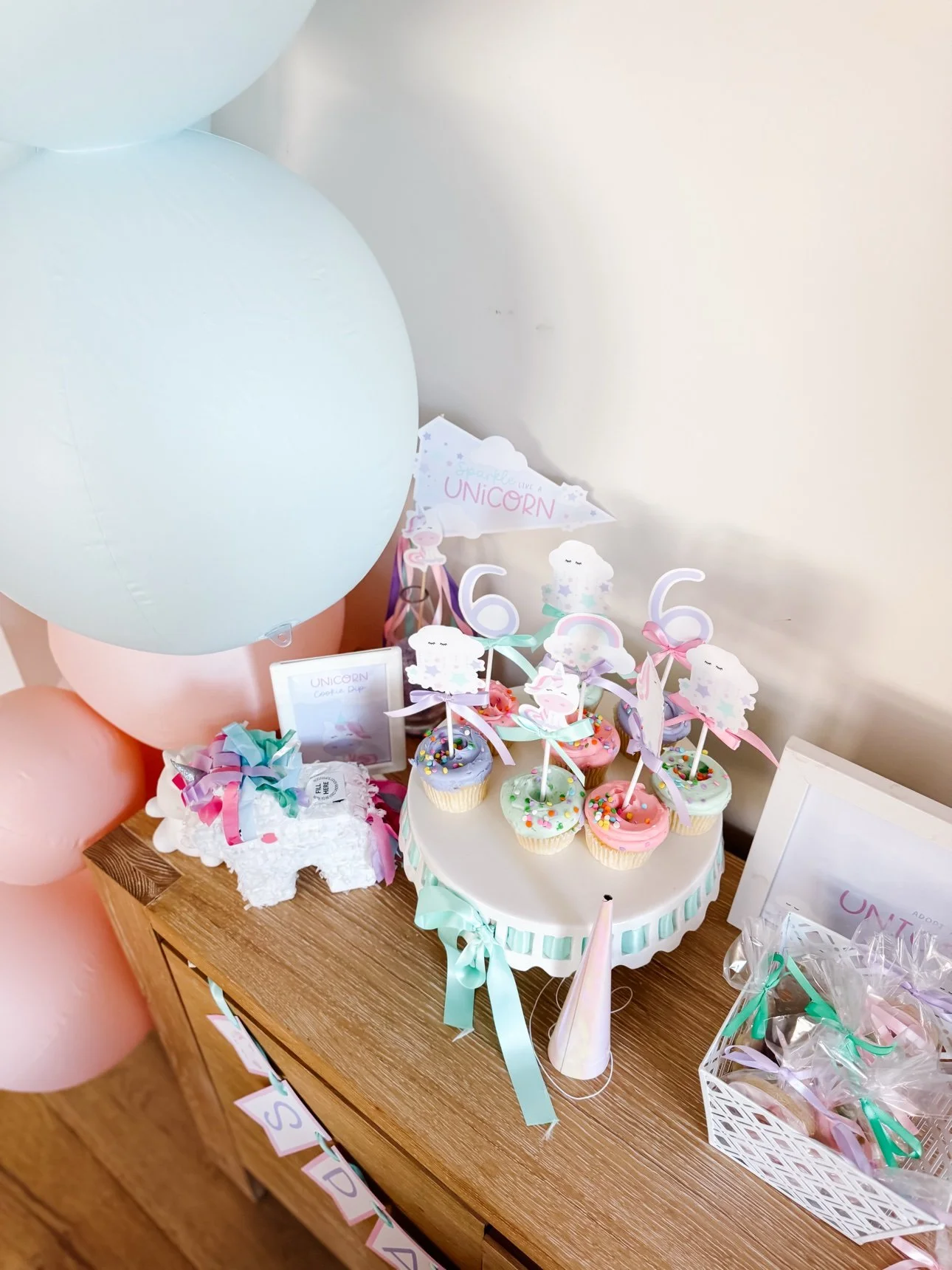 Wrapped unicorn sugar cookies laid out as party favors