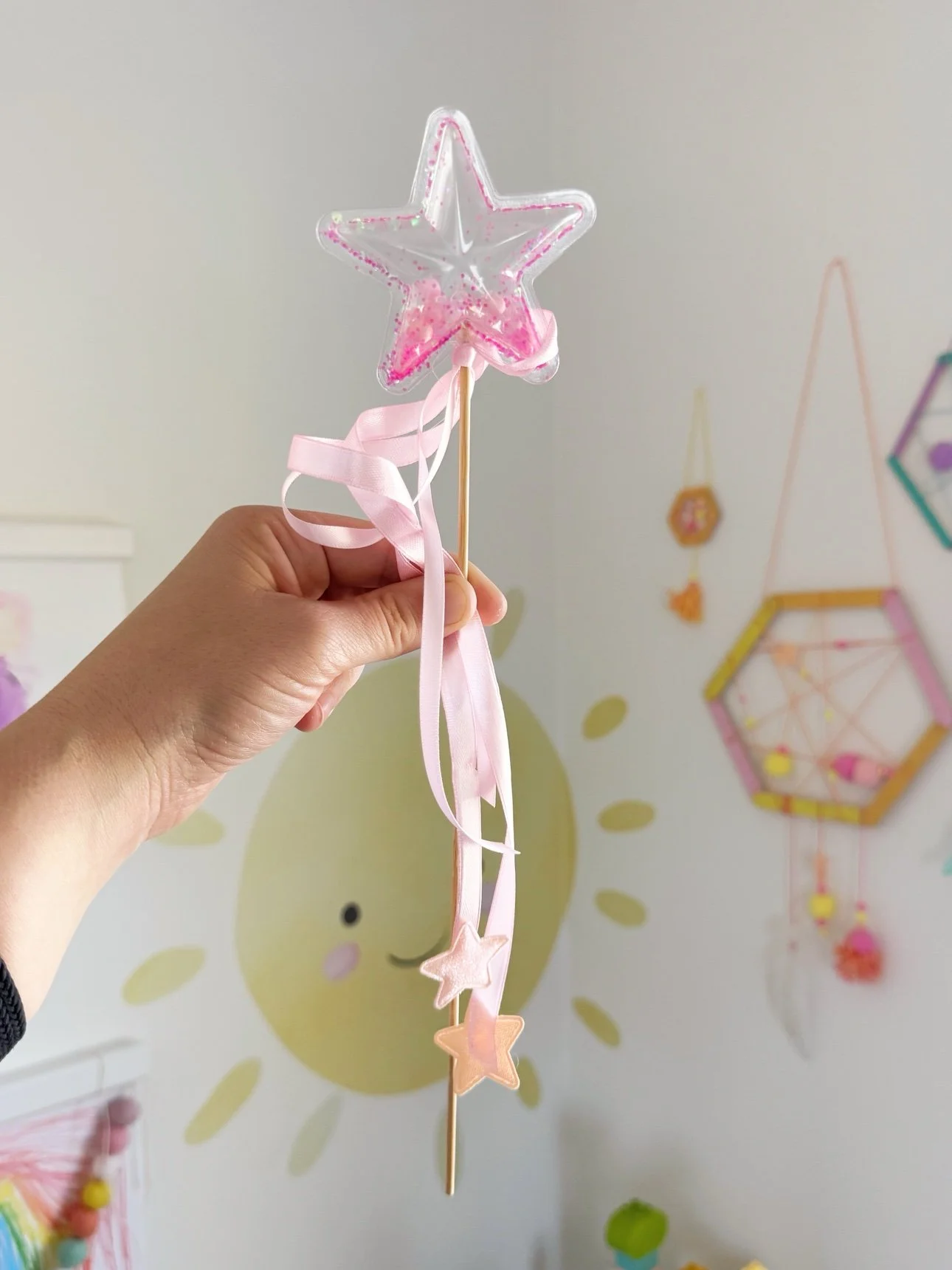 Finished pink glitter star shaker wand held up