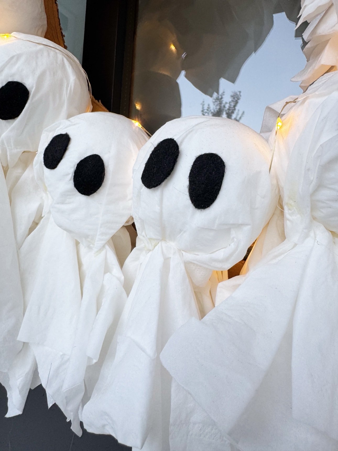 Close-up of tissue ghosts with felt eyes on the indoor wreath