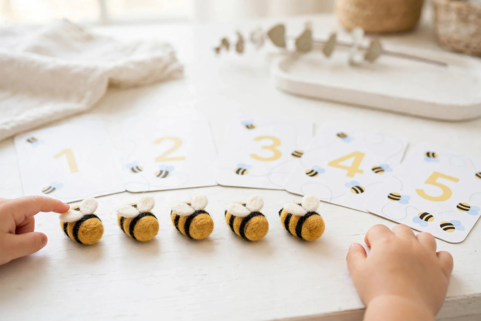 Teaching toddler to count with needle-felted bees and number cards