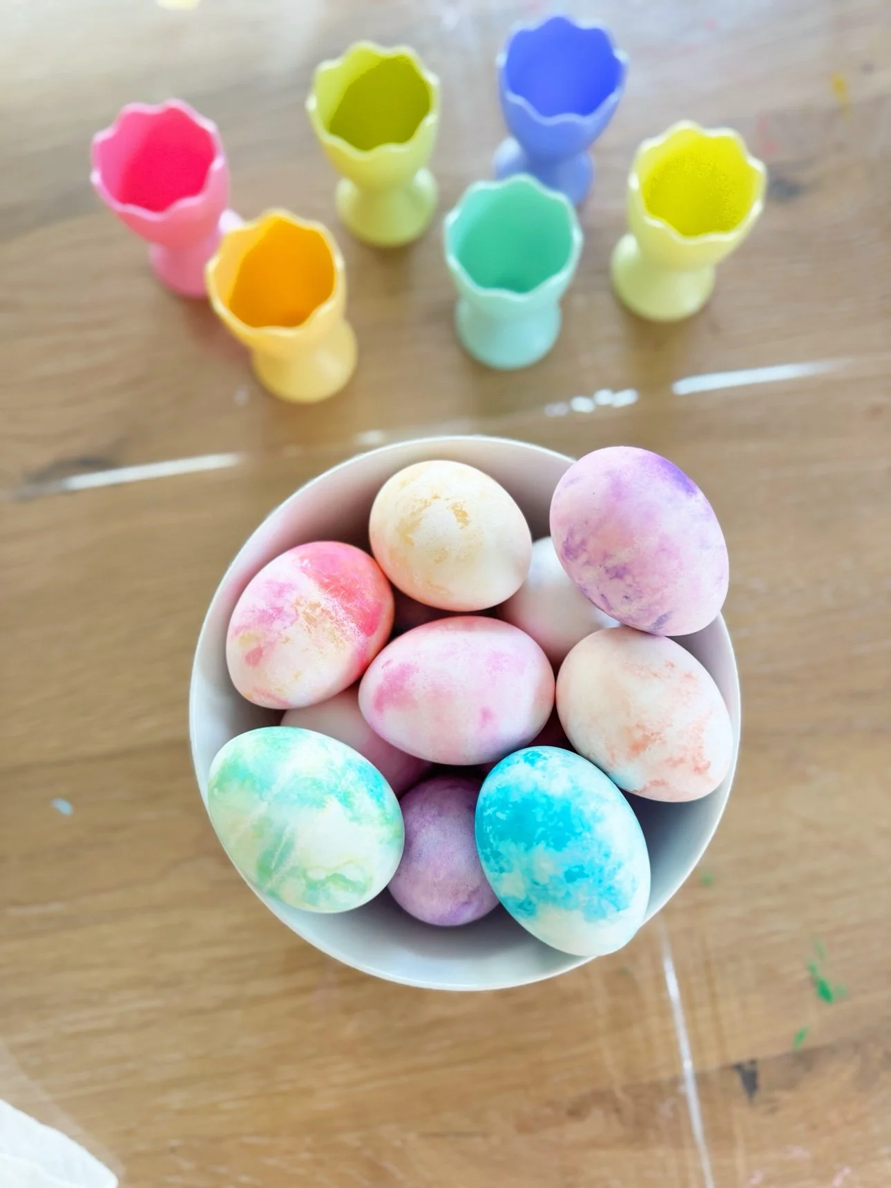 A bowl of finished pastel marbled Easter eggs