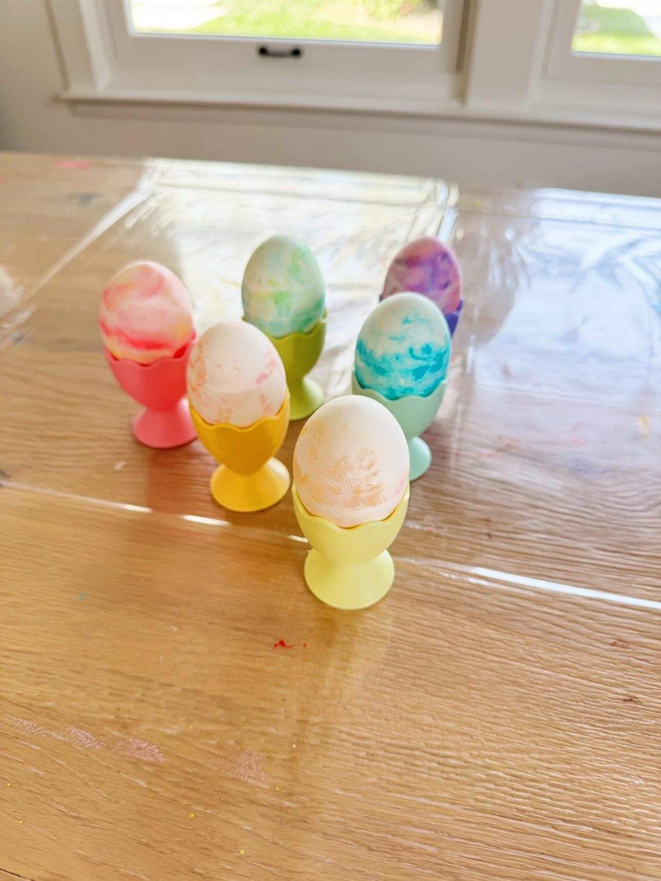 Finished marbled Easter eggs displayed in pastel egg cups