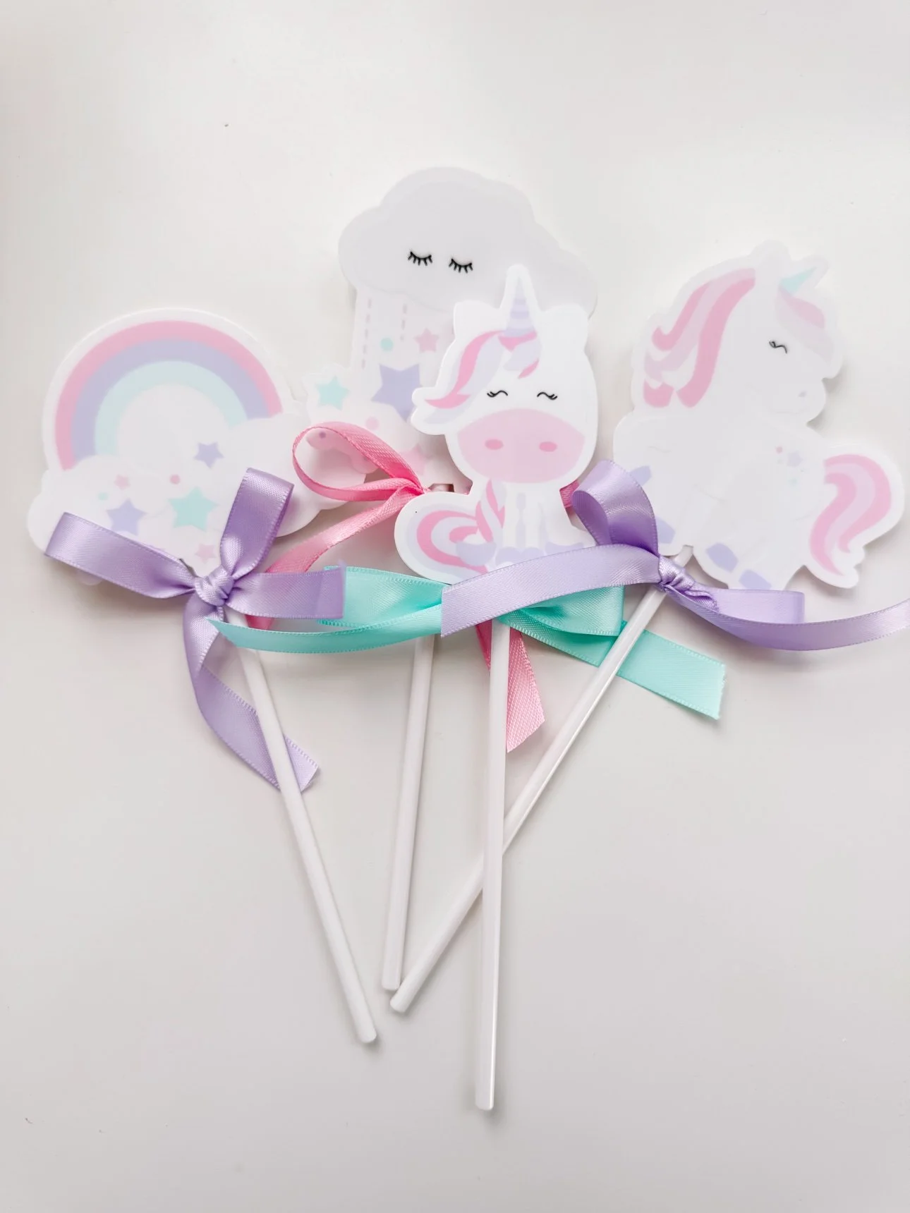 Bouquet of DIY unicorn cupcake toppers with pastel ribbon bows
