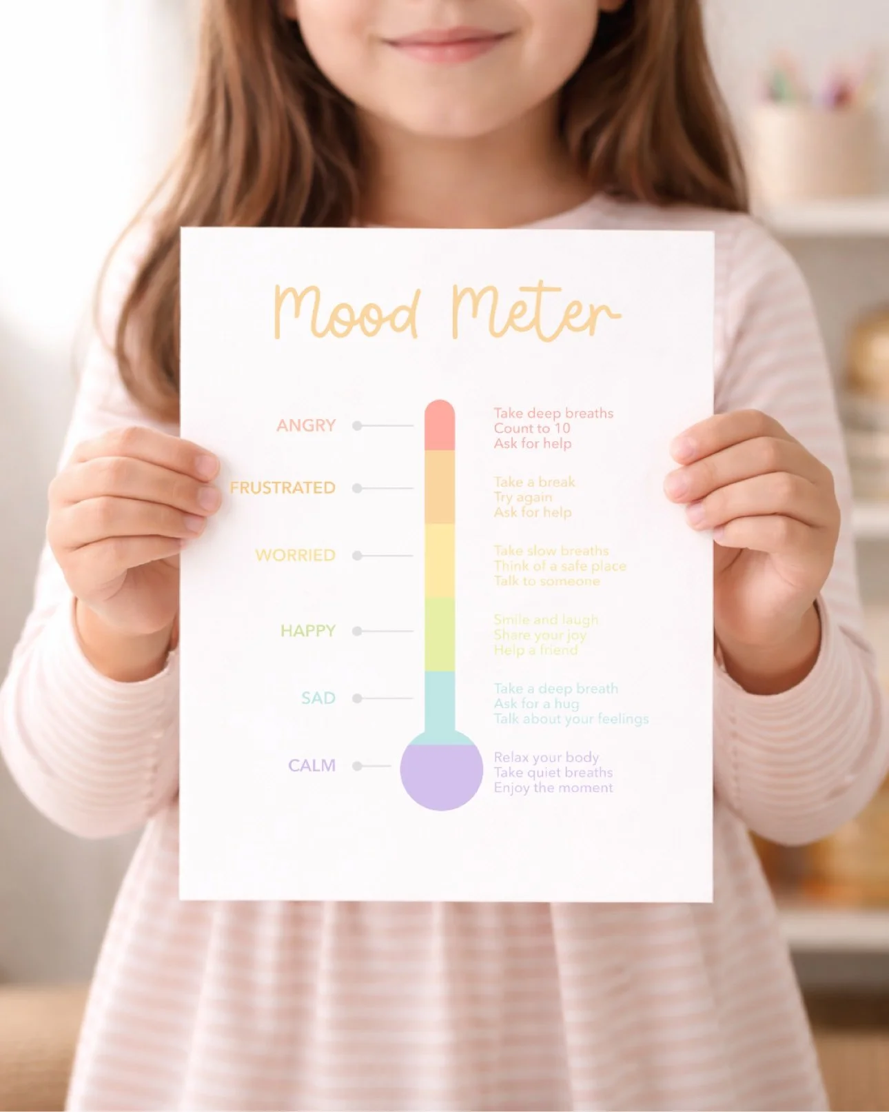 Child holding the printable mood meter poster