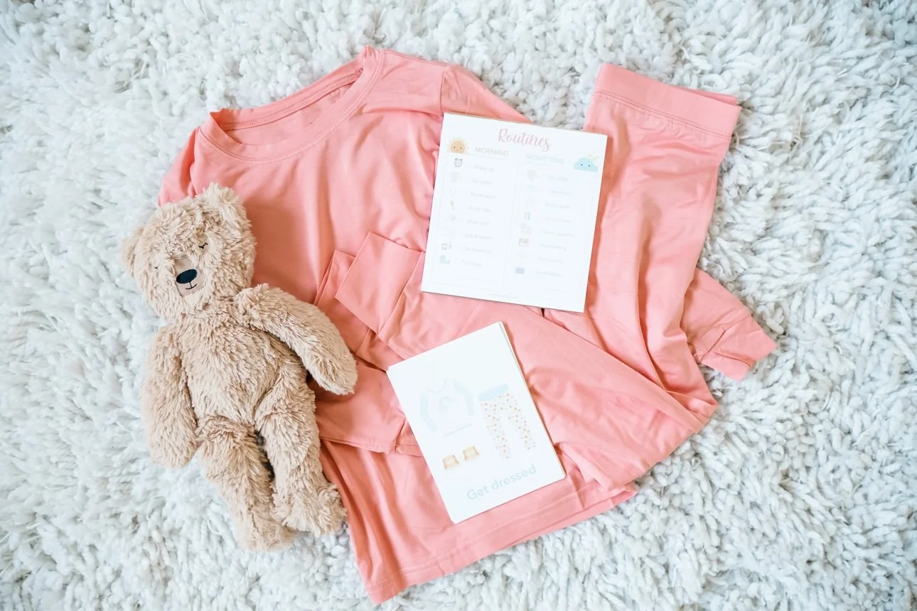 Pink pajamas and a teddy laid out for a toddler's bedtime routine