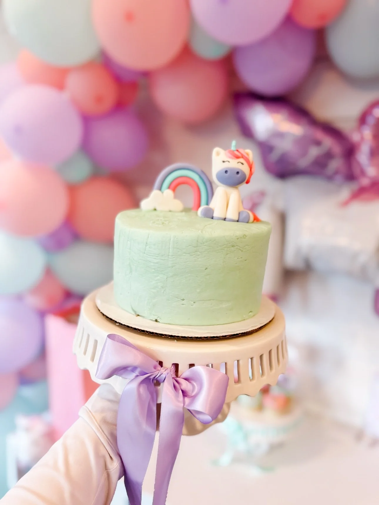 Mint green unicorn birthday cake with fondant unicorn and rainbow topper