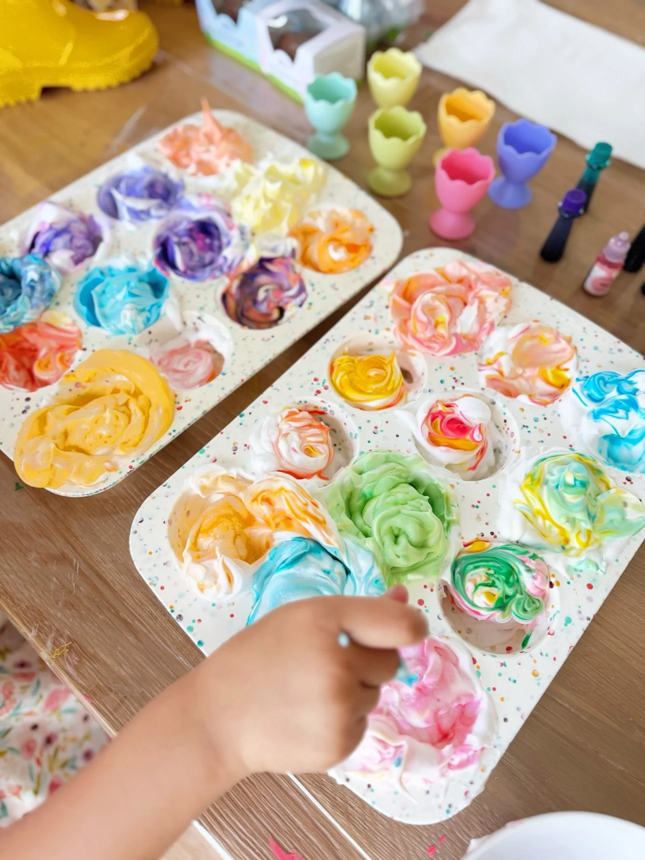 Swirling food coloring through shaving foam in a muffin tin
