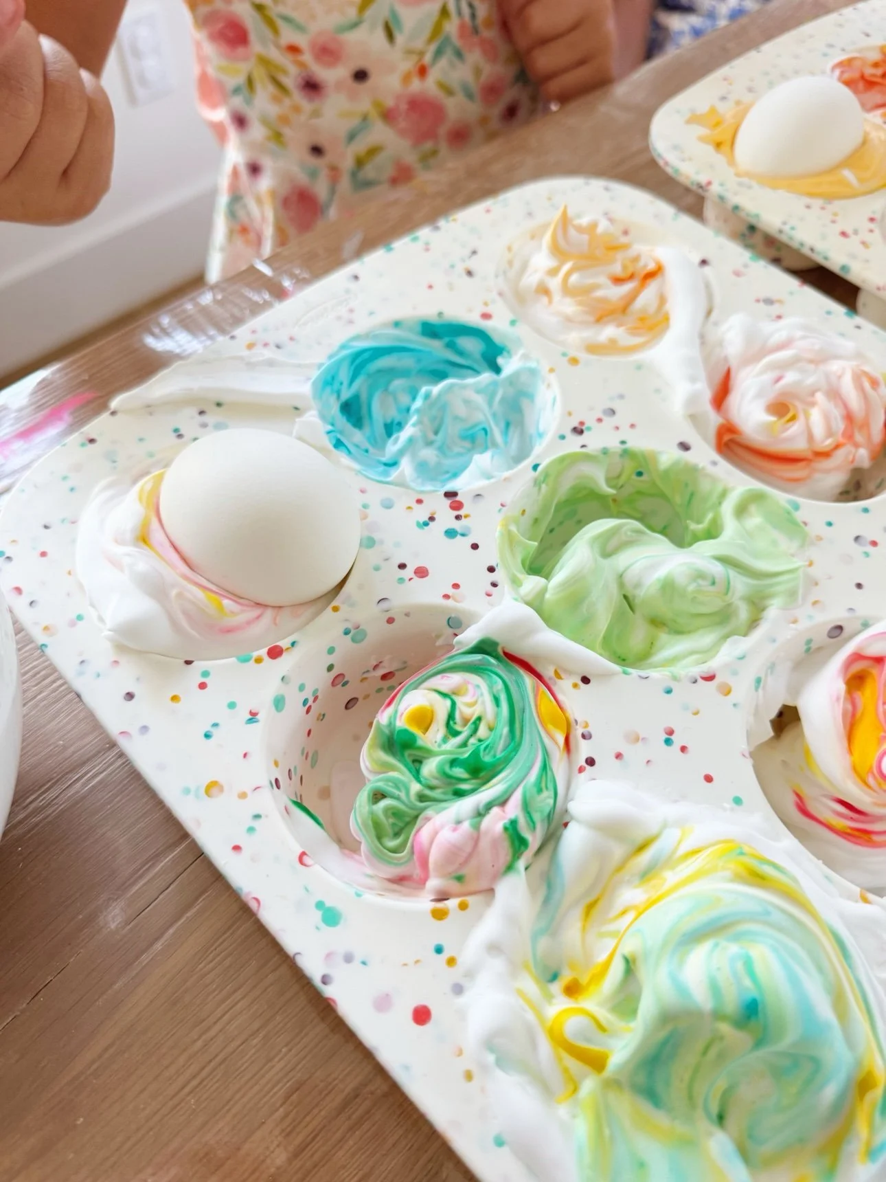 Eggs resting in swirls of colorful shaving foam