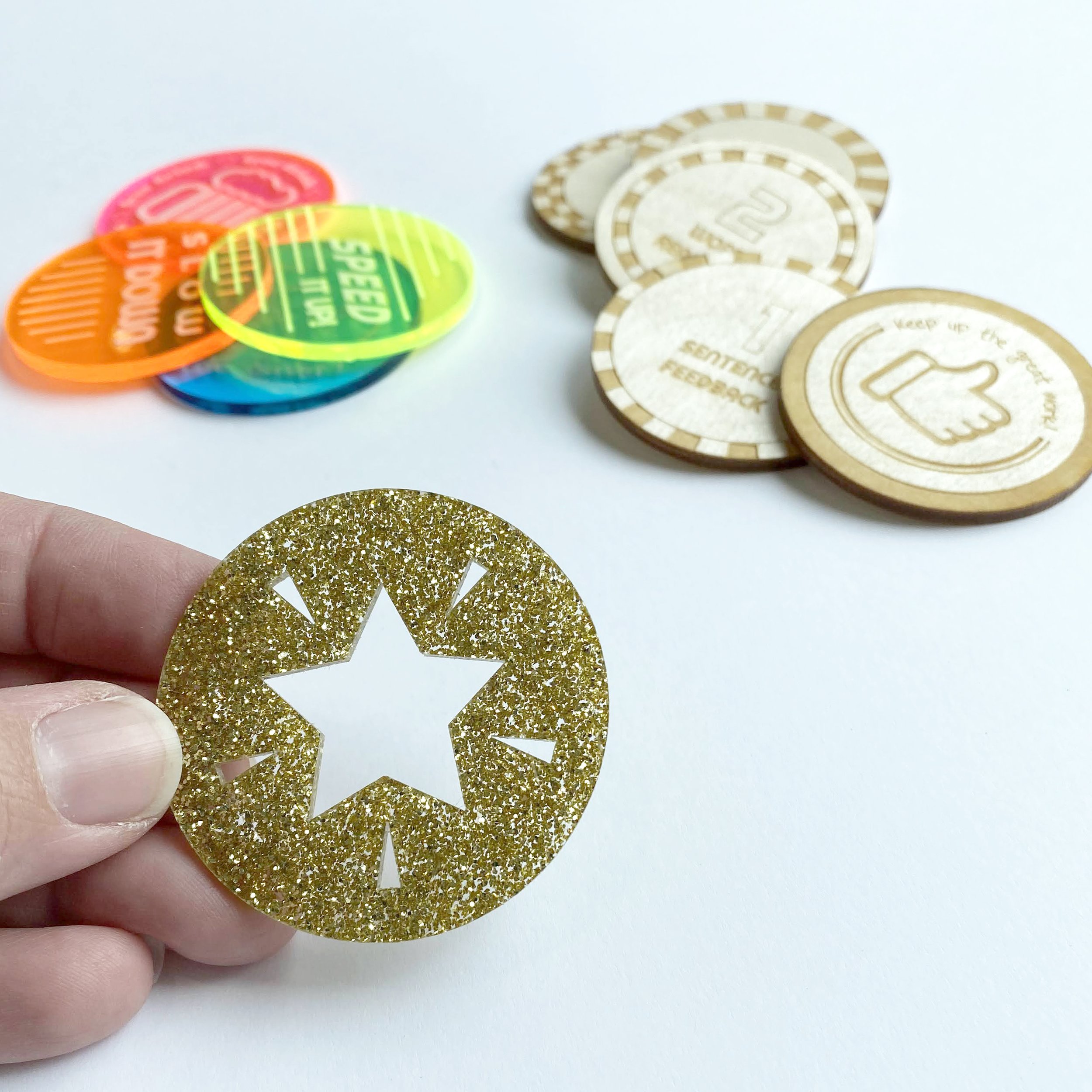 Hand holding laser cut token.