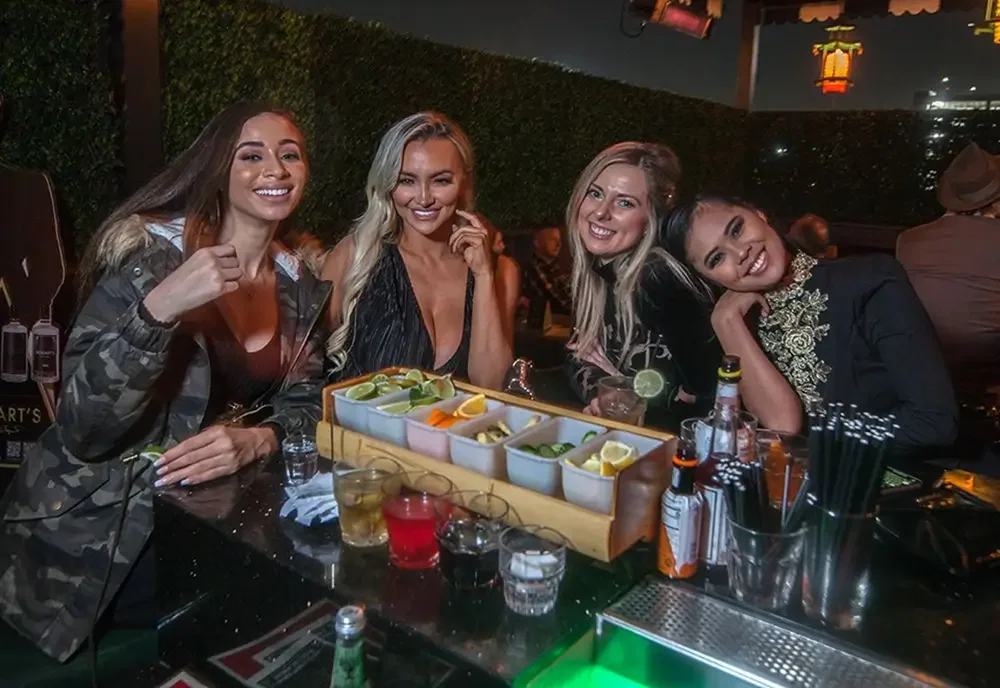 Guests at the bar with cocktails