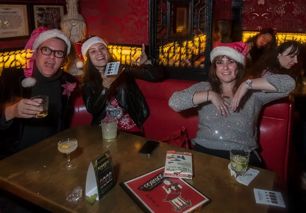 Holiday guests at a table wearing Santa hats