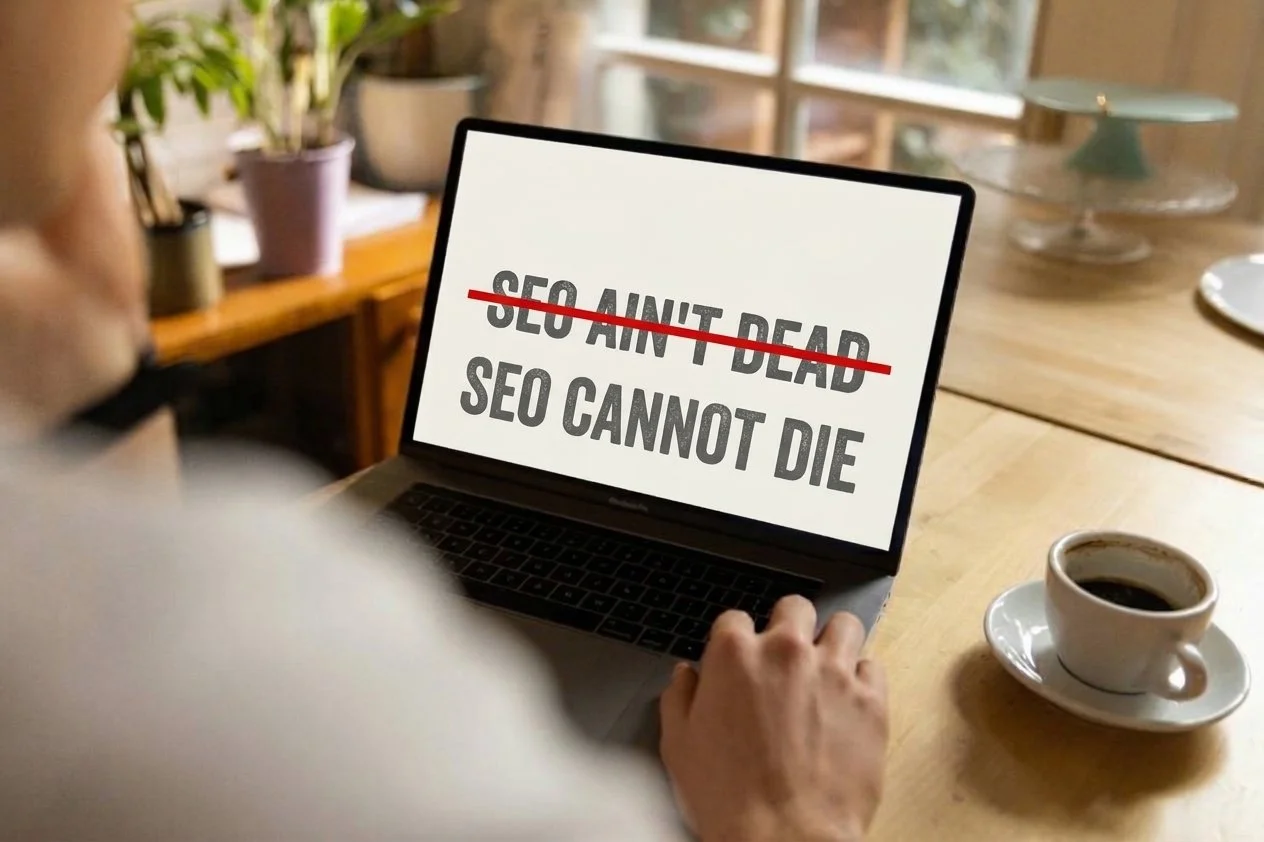 A laptop screen reading SEO ain't dead, crossed out, above SEO cannot die