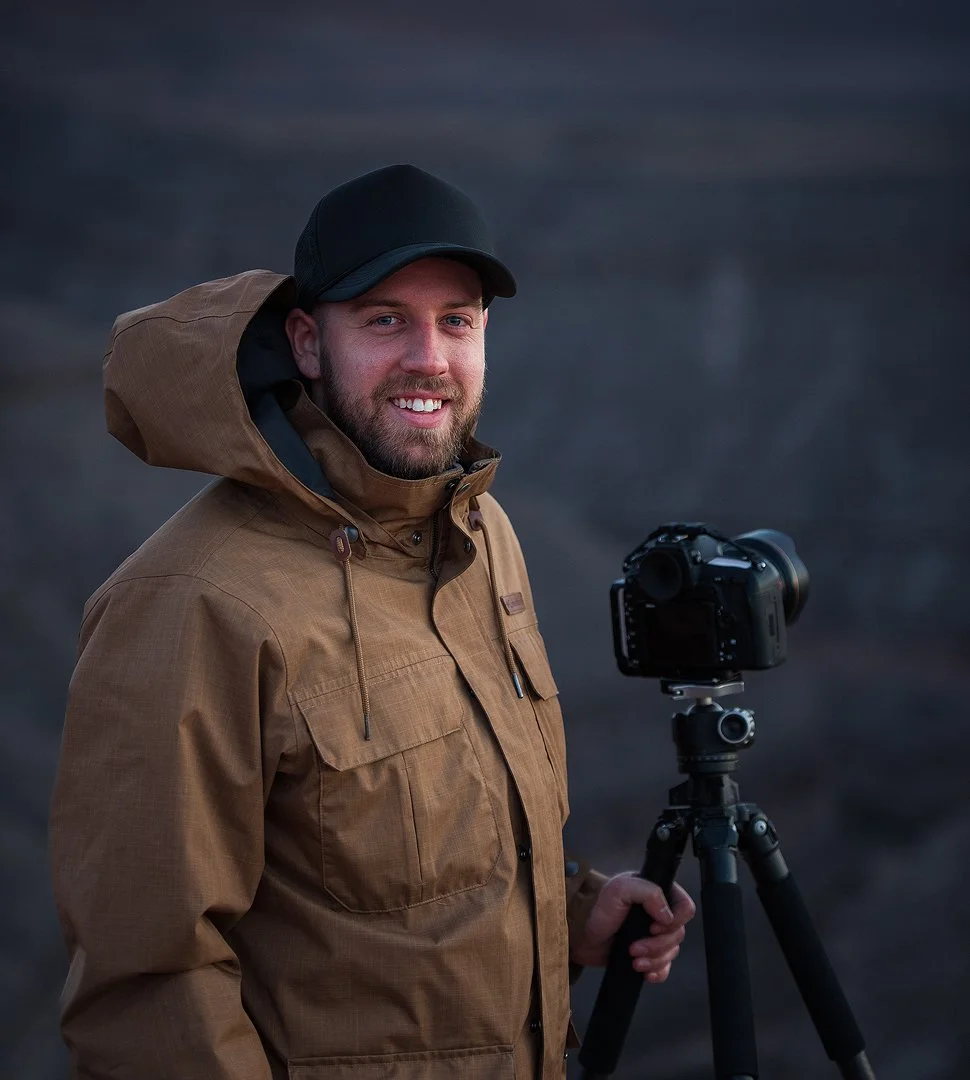 Dylan Knight with a camera and tripod