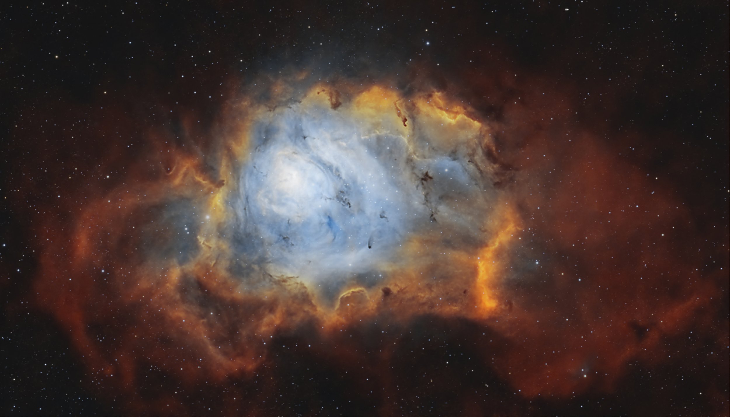 The Lagoon Nebula with blue oxygen emission, gold hydrogen structure and dark dust lanes, processed from DWARF Mini data.