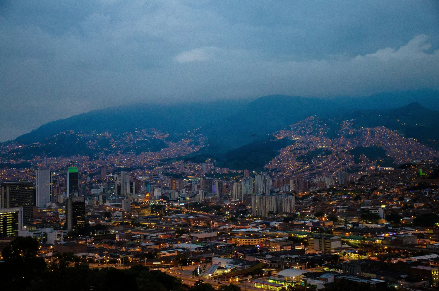 Medellín at night with mist over the hills