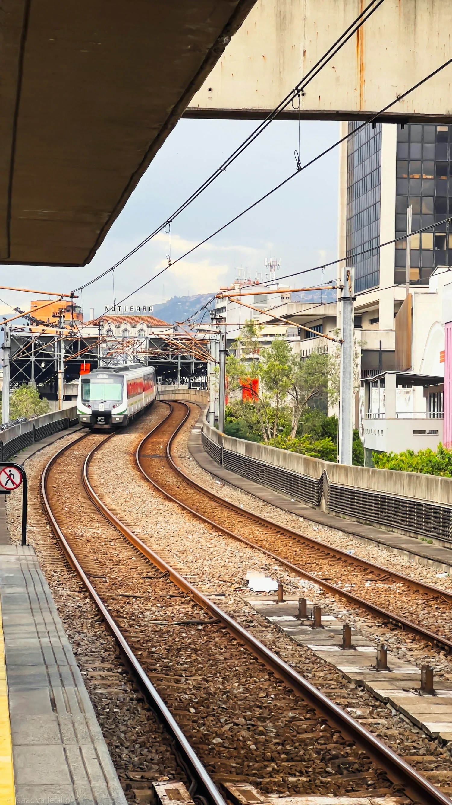 Metro de Medellín train crossing the city