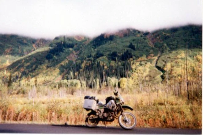 Loaded motorcycle on an autumn road in Alaska
