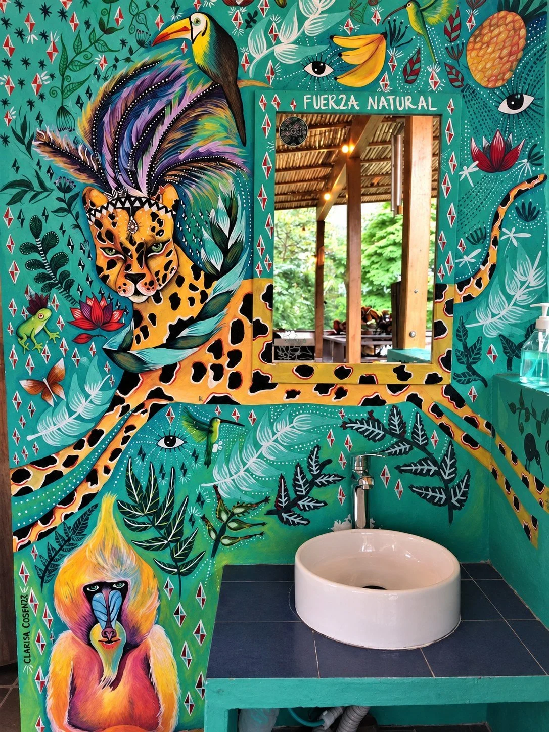 Hand-painted jungle mural around a sink