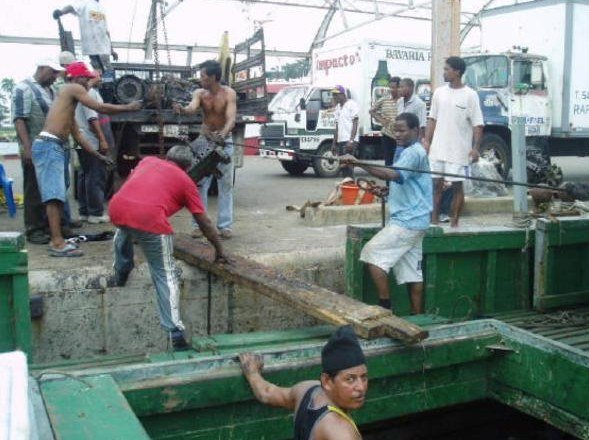 Loading the motorcycle onto a boat from Panama to Colombia