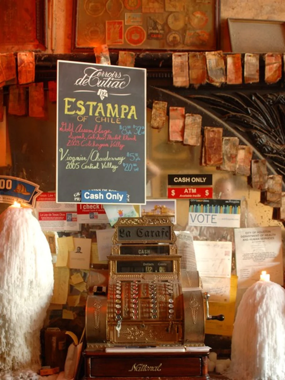 Vintage cash register and memorabilia inside La Carafe