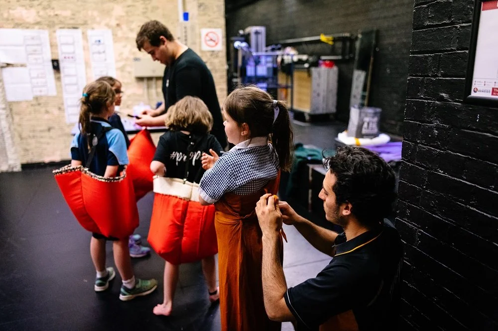Students getting ready backstage before a performance