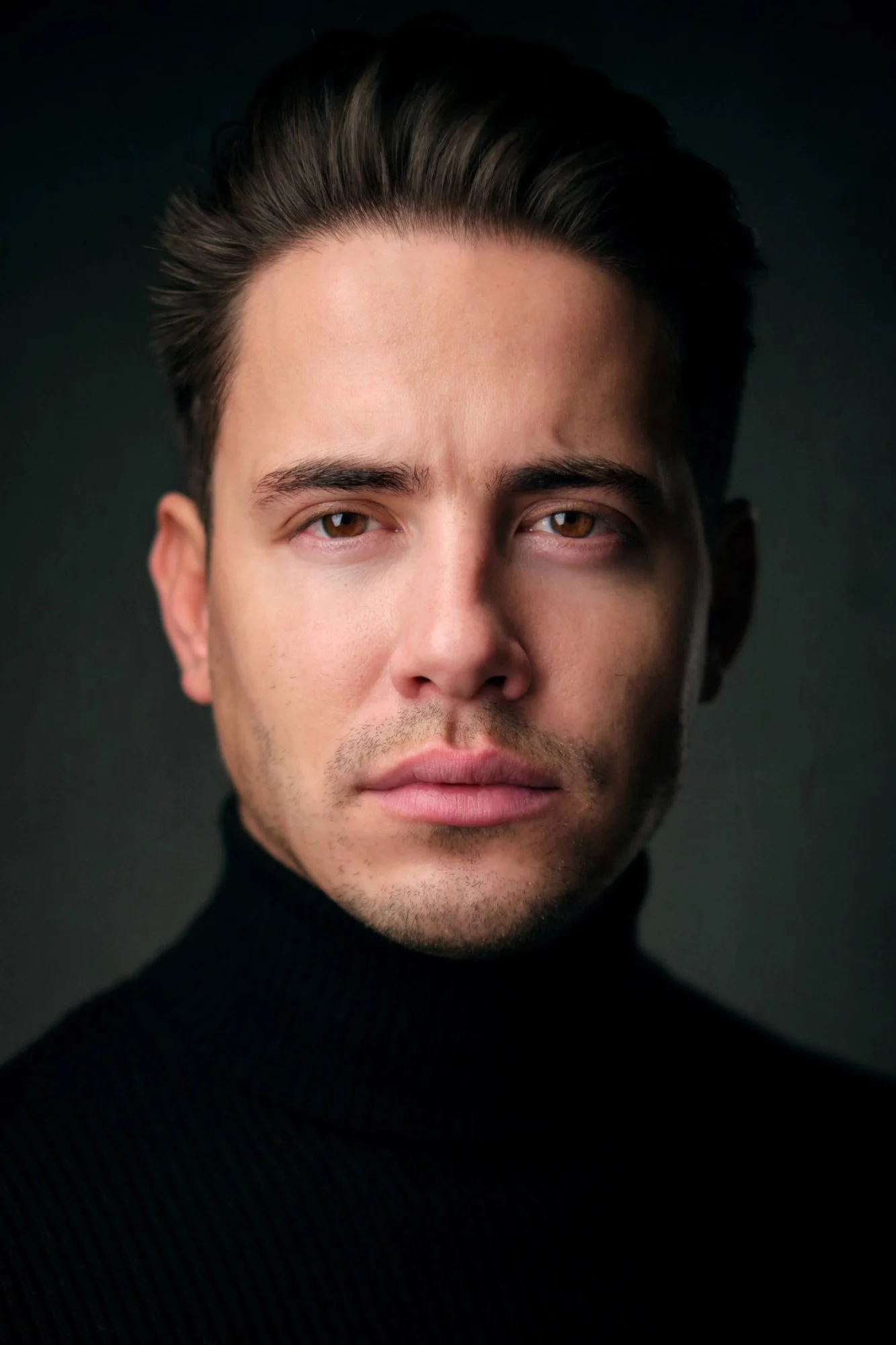 Dramatic professional headshot of a man in a black turtleneck, Garden City NY photographer