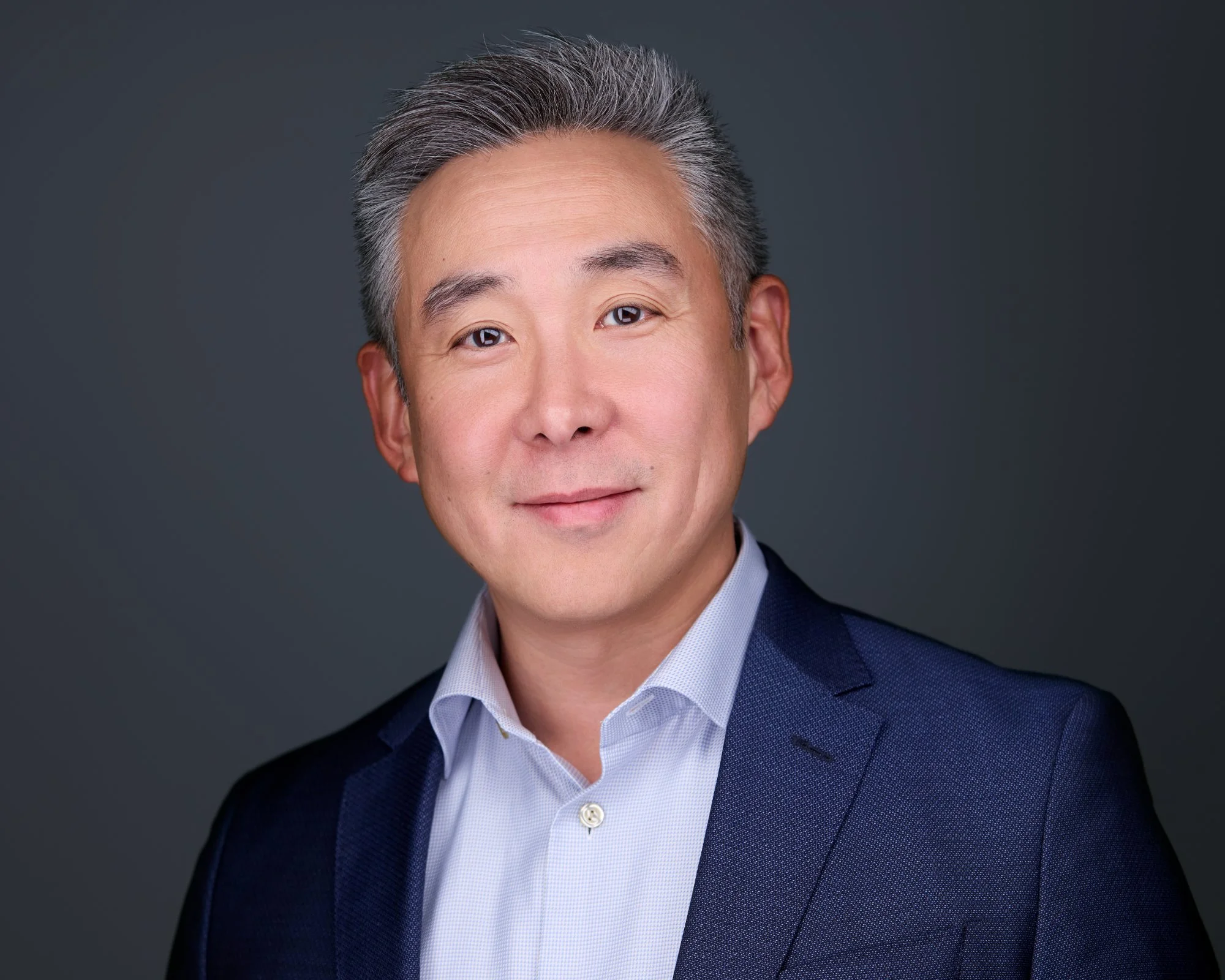Corporate headshot of a businessman in a navy suit, Long Island photographer