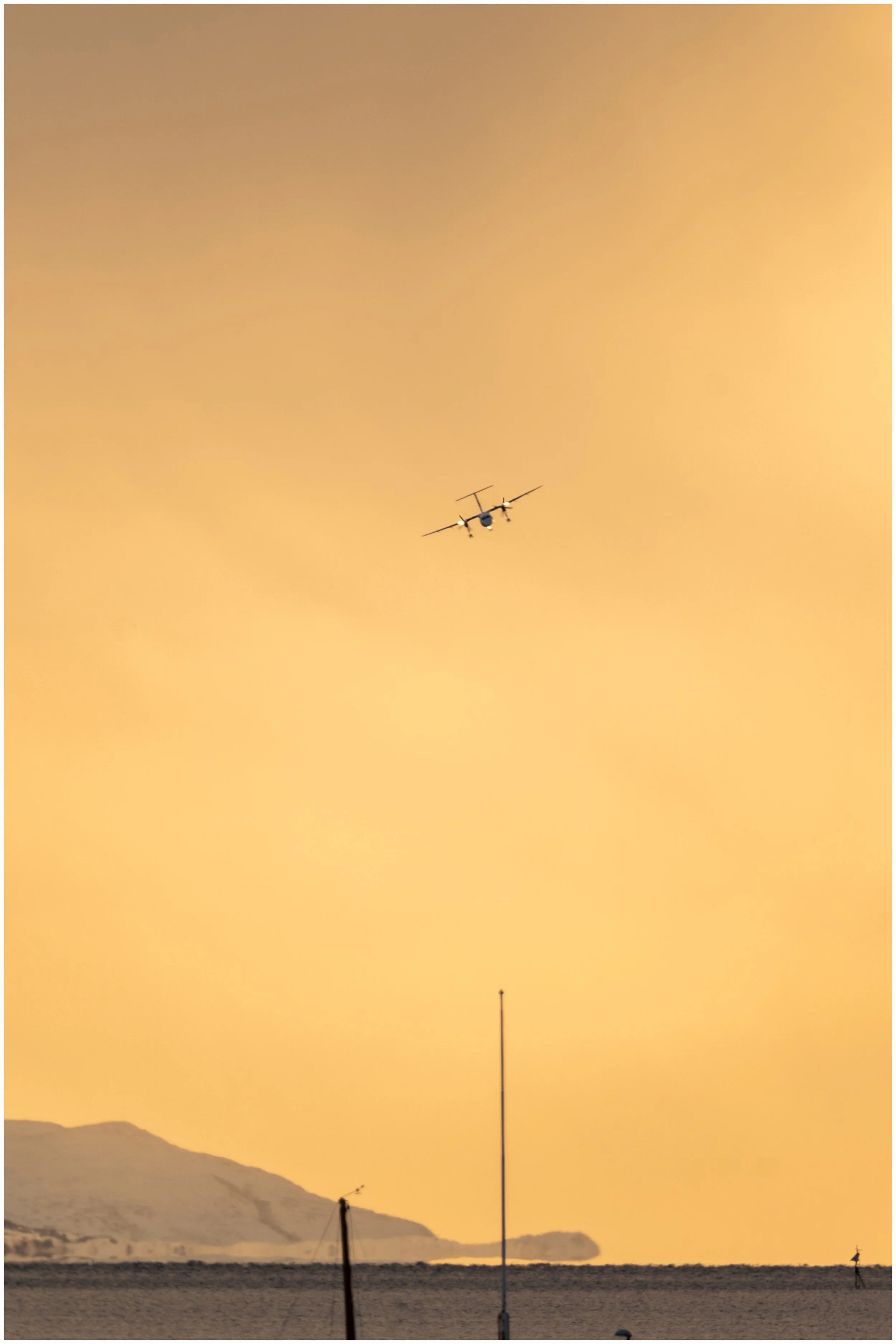Plane landing at sunset in Lofoten