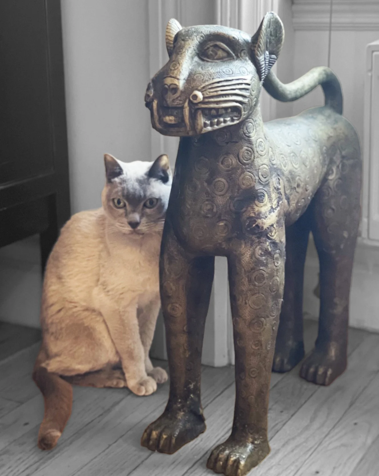 Cat beside bronze statue
