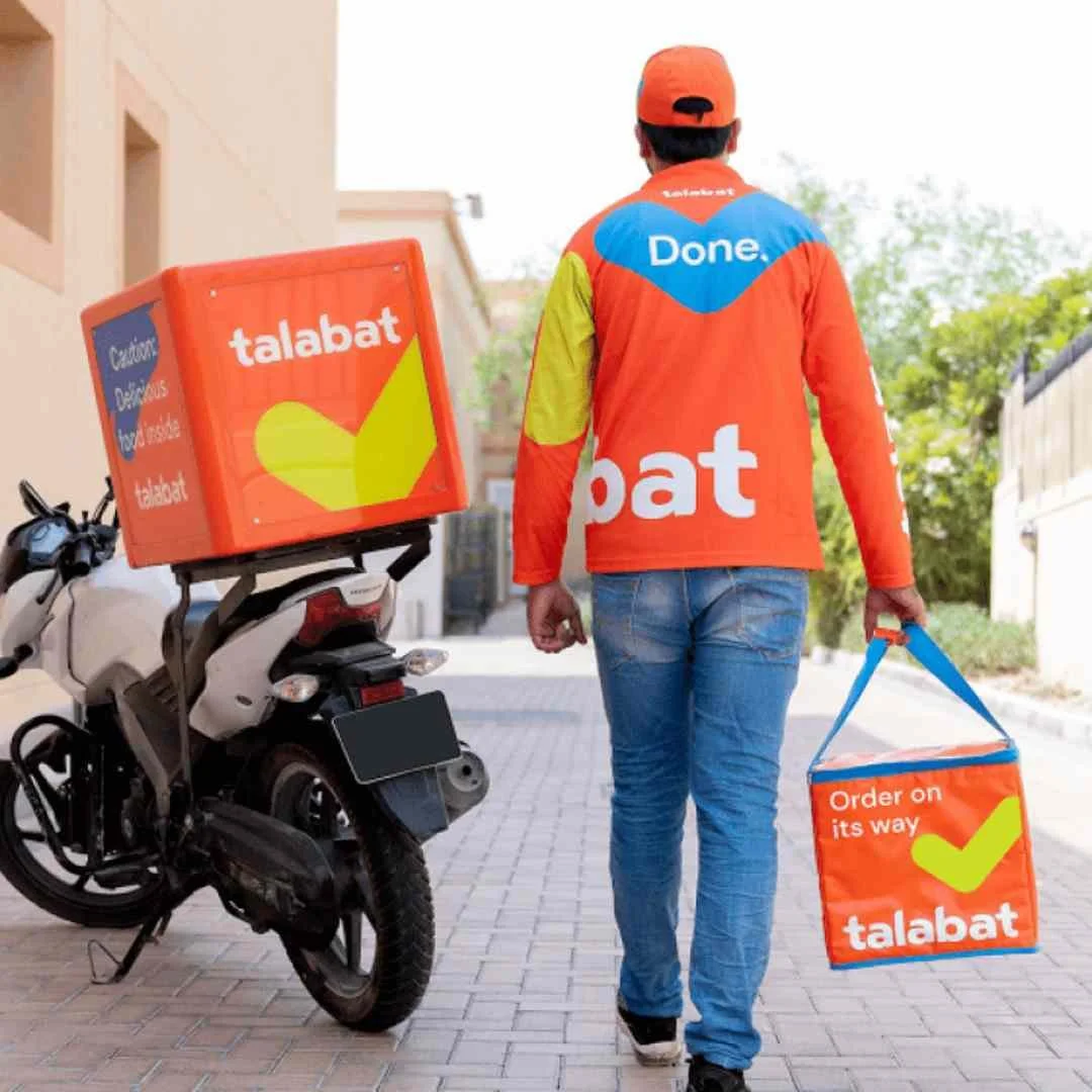 Rear view of a rider wearing the Talabat long-sleeve top