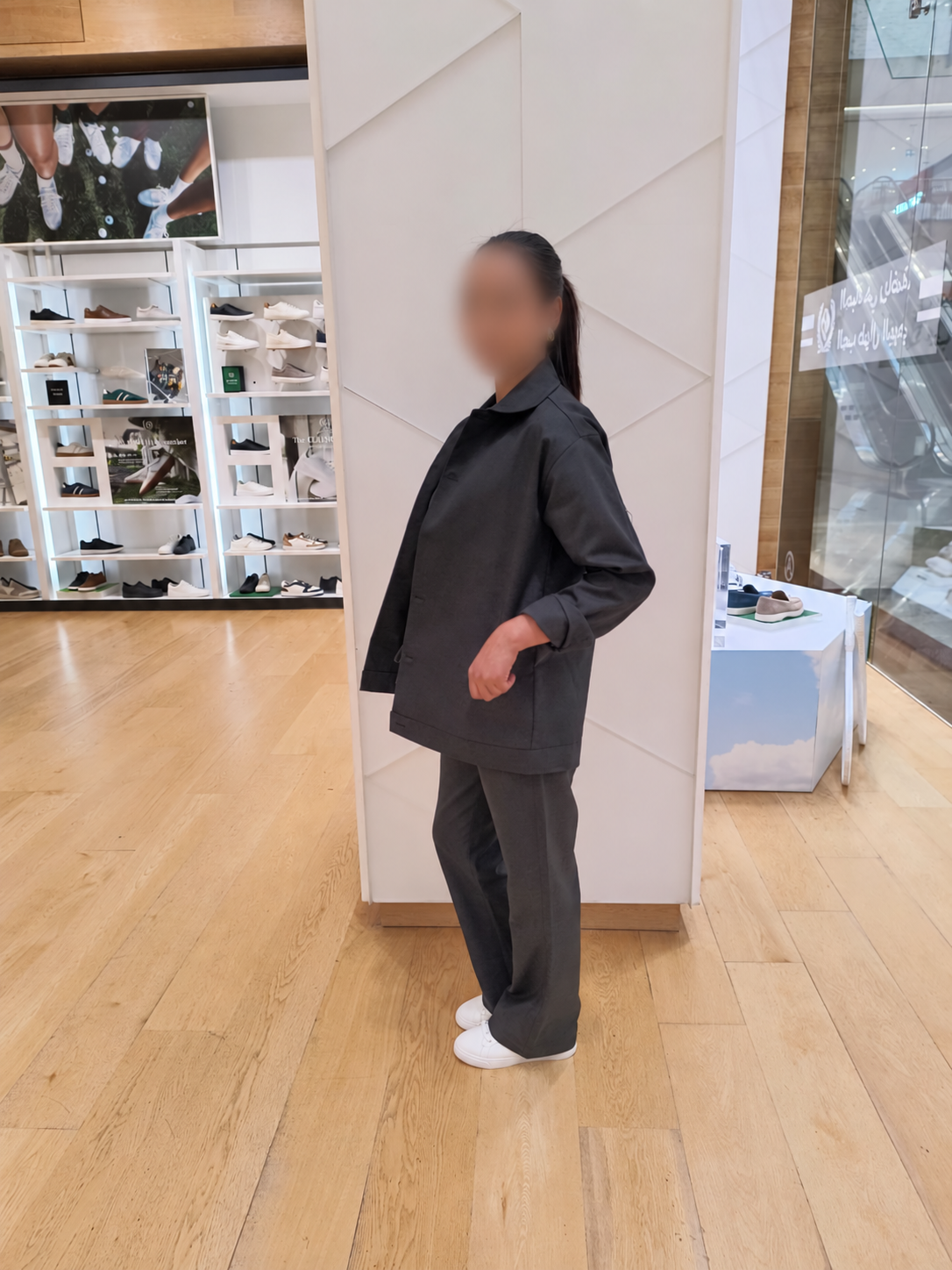 ALDO staff member wearing the charcoal twill uniform in store